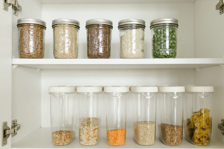 Pantry shelf with grains in glass jars and dry goods in containers