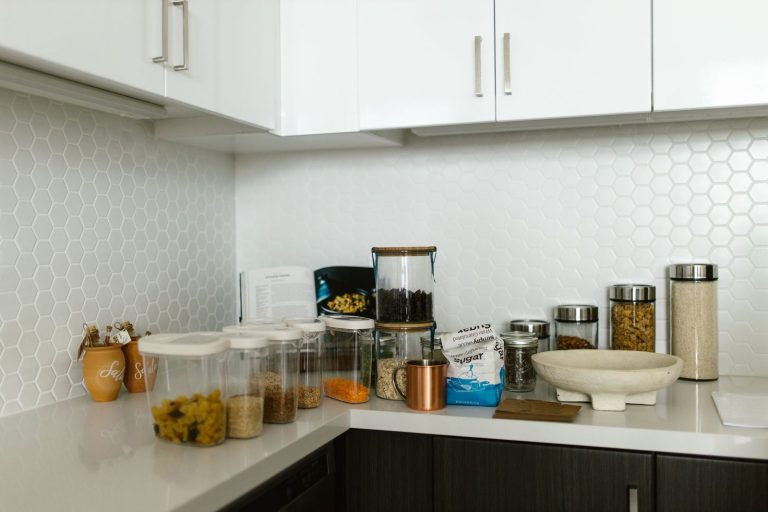 Organized glass jars and food storage containers on a kitchen counter